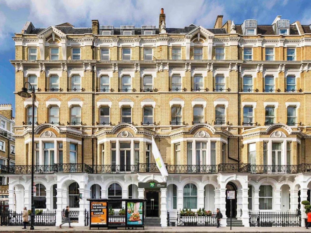 a large yellow building with people standing in front of it at ibis Styles London Gloucester Road in London