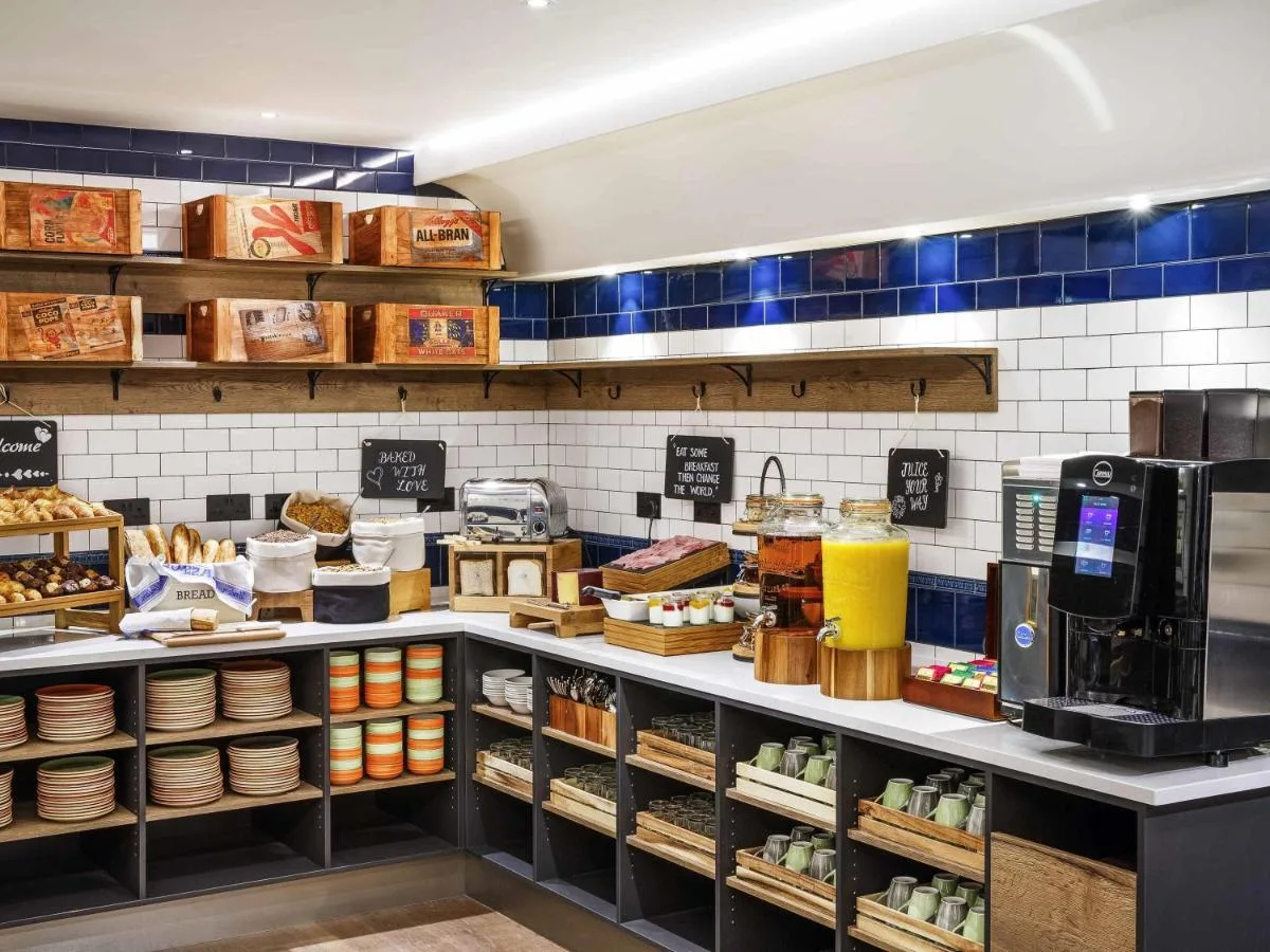 a bakery counter with a lot of food at ibis Styles London Gloucester Road in London